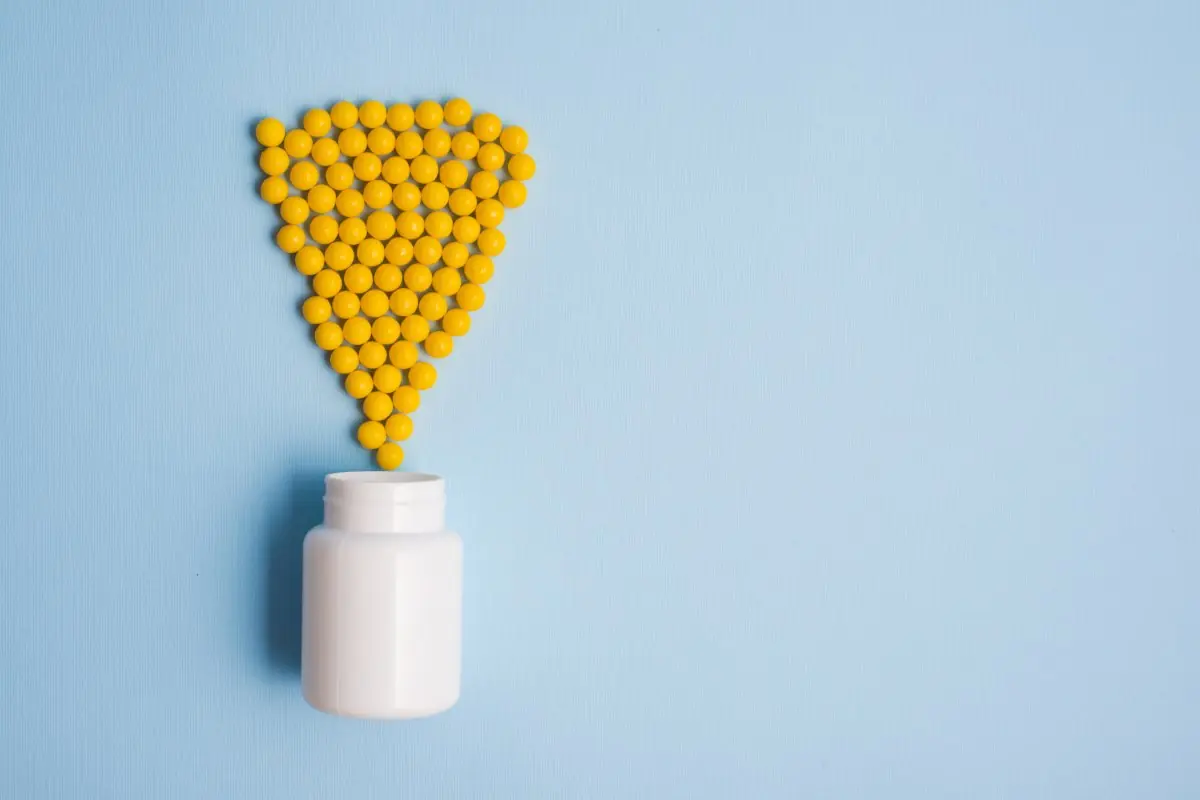 Supplements spilling out of a bottle.