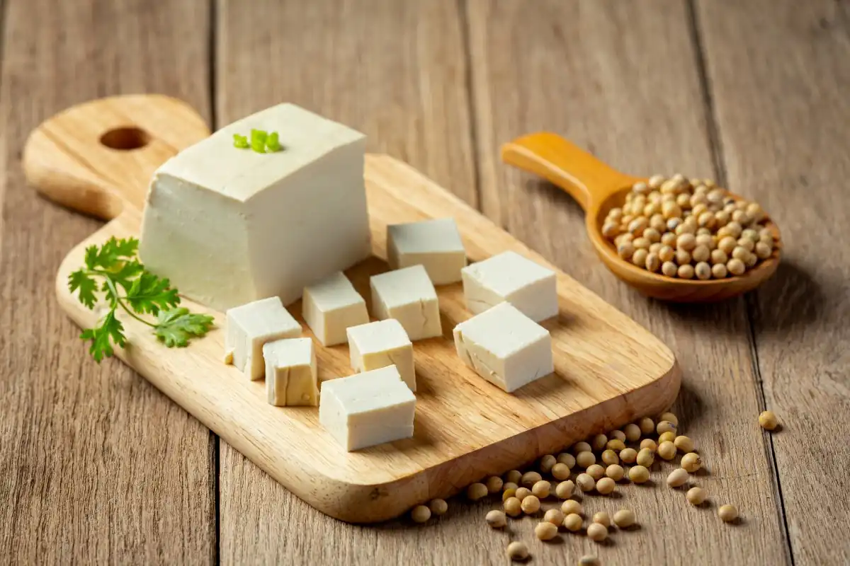 tofu and soy beans arranged on a wood table